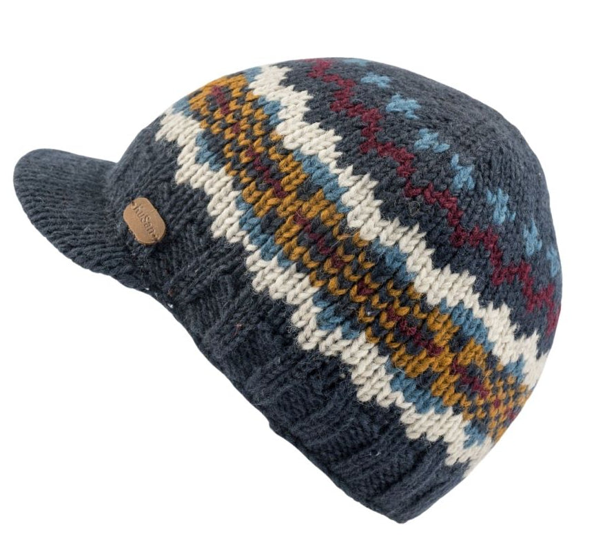 Knitted beanie hat with a peak visor. Navy blue with patterned zig zag stripes in white, blue, mustard and burgundy. 